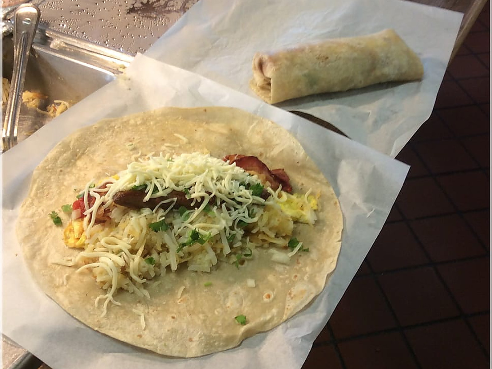 Breakfast burrito, built to order — Eggs, hash browns, bacon and cheese on a flour tortilla