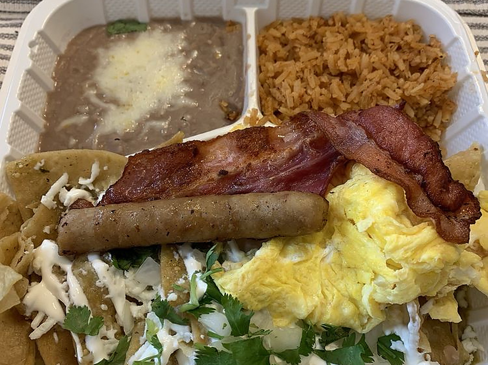 Chilaquiles verdes combo — Crispy tortillas, crema, queso fresco, eggs and bacon