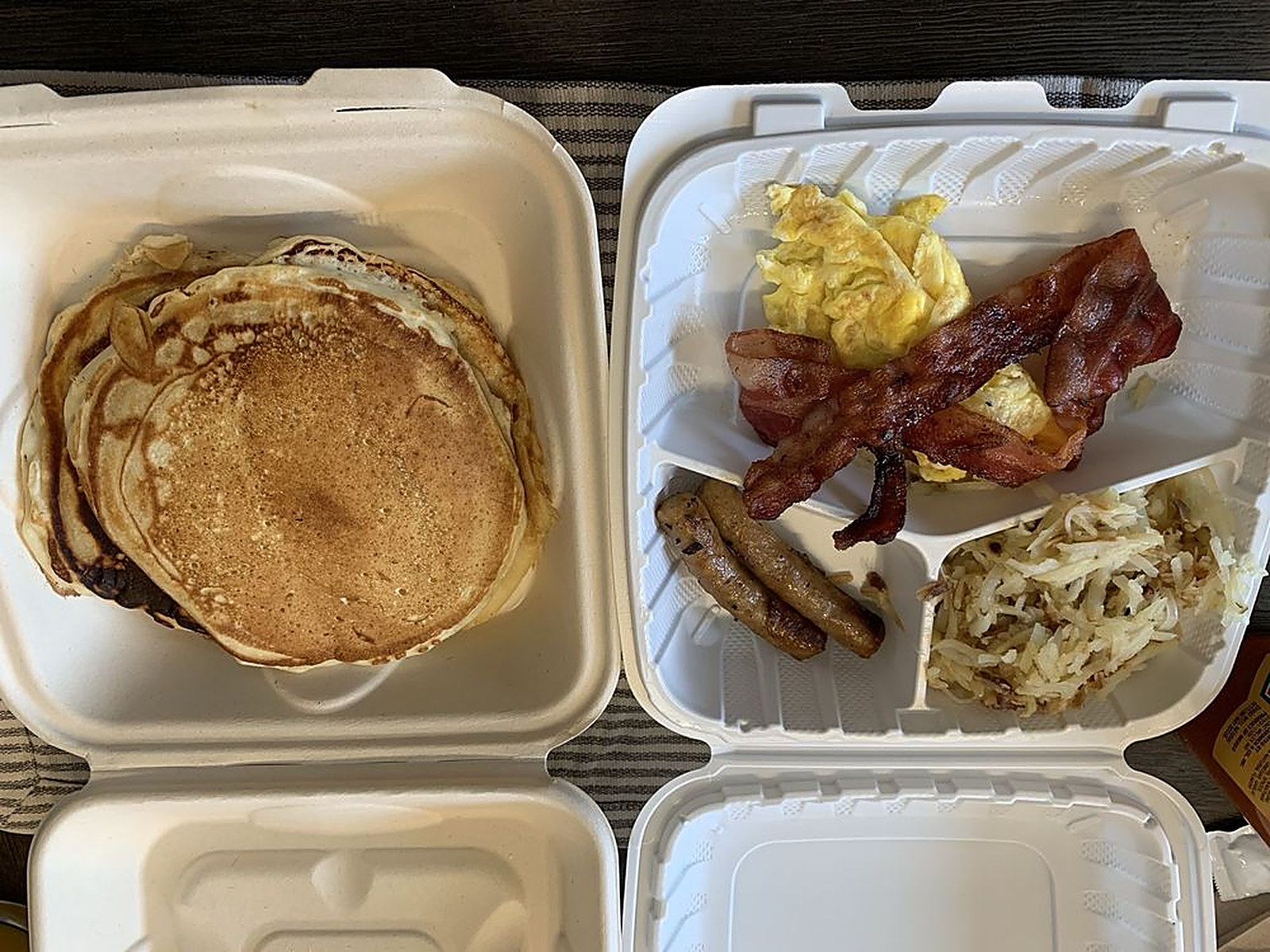 Short stack breakfast combo — Pancakes, eggs, bacon, sausage and hash browns to go