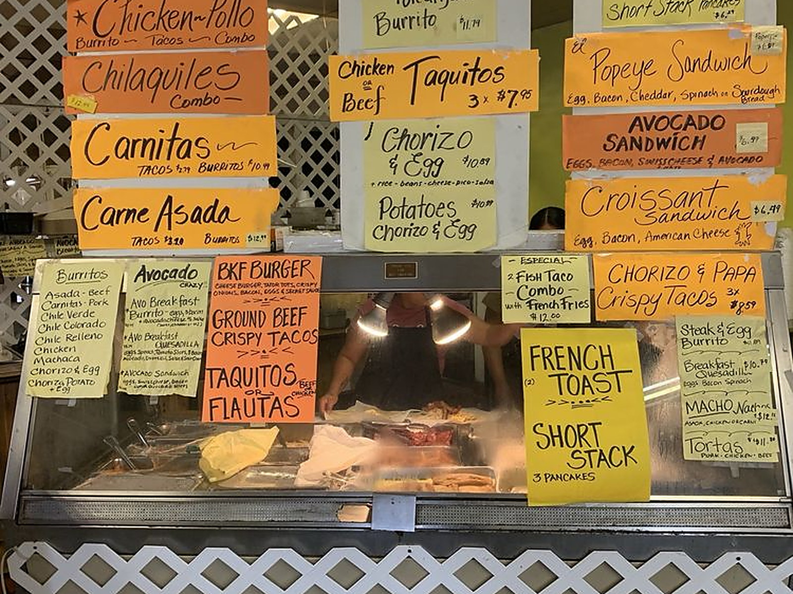 Order at the counter — Hand-written boards over the steam table
