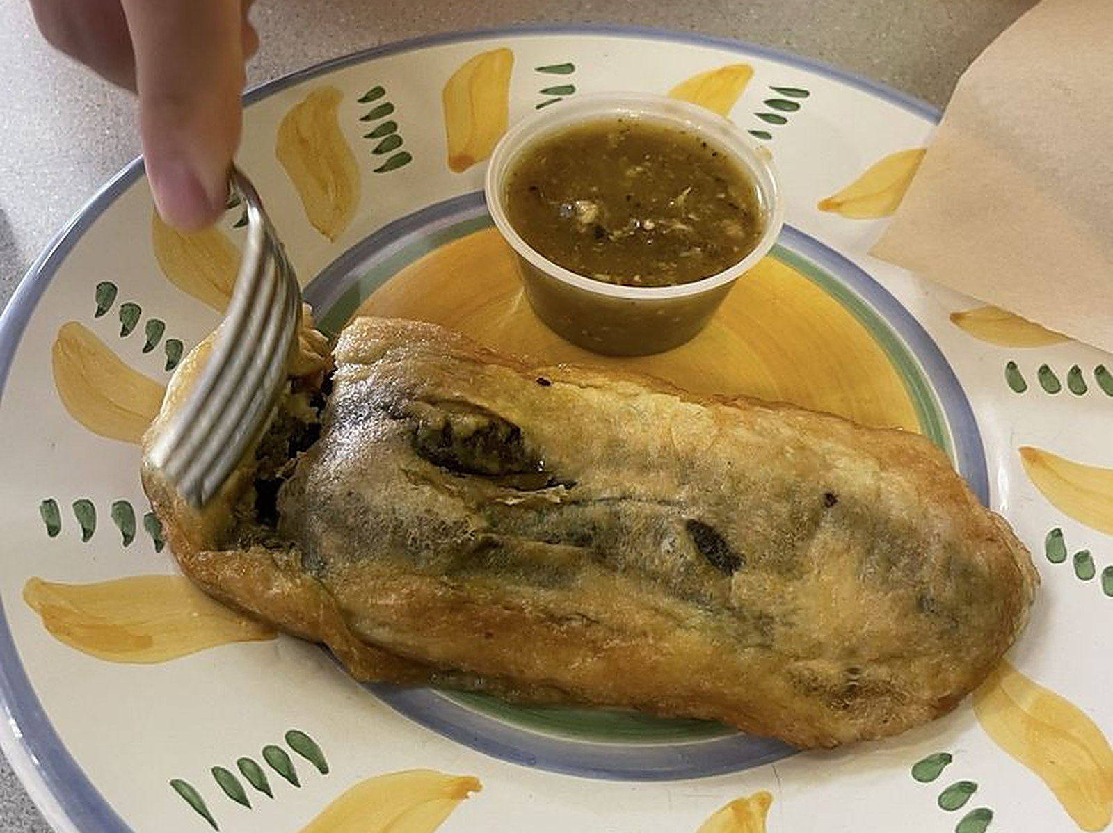 Chile relleno on the plate — Fried in egg batter, with salsa verde on the side