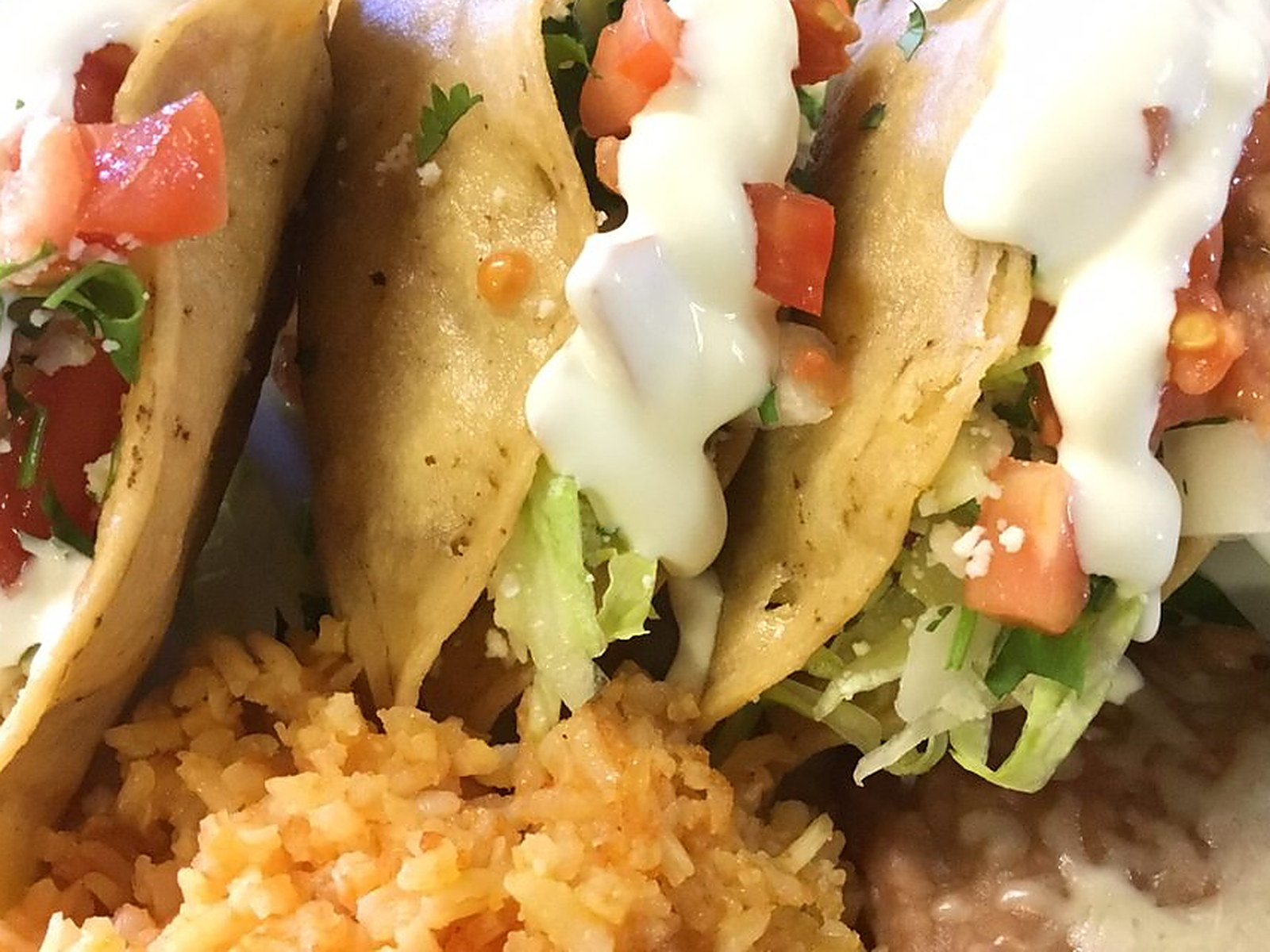 Crispy tacos with rice and beans — Lettuce, pico de gallo, crema and queso fresco